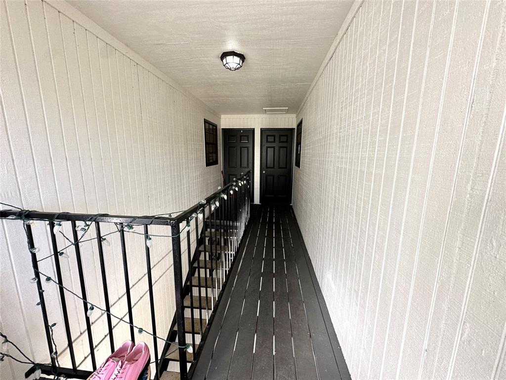 2006 Jane Street, Unit H Longview, TX 75601 - Photo 10 of 12 a view of a balcony with wooden floor and stairs