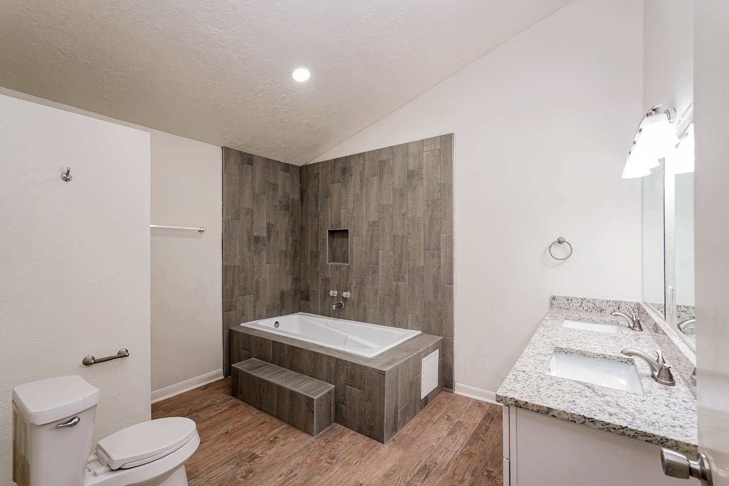 34306 Conroe Huffsmith Road Magnolia, TX 77354 - Photo 11 of 17 a spacious bathroom with a granite countertop sink a toilet and shower