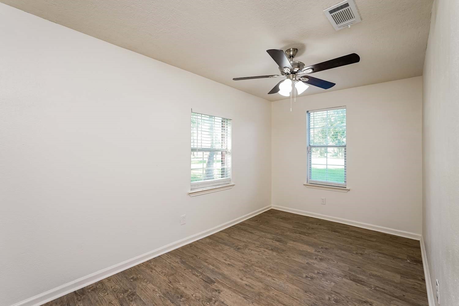 34306 Conroe Huffsmith Road Magnolia, TX 77354 - Photo 12 of 17 an empty room with a window and a fan