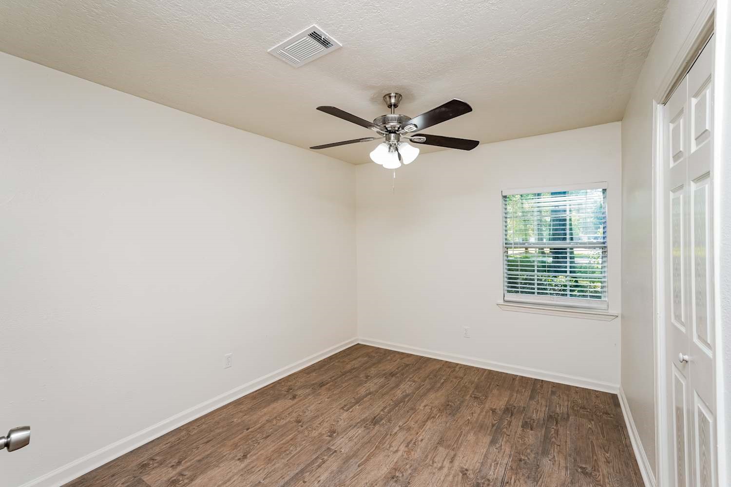 34306 Conroe Huffsmith Road Magnolia, TX 77354 - Photo 14 of 17 an empty room with a window and a fan