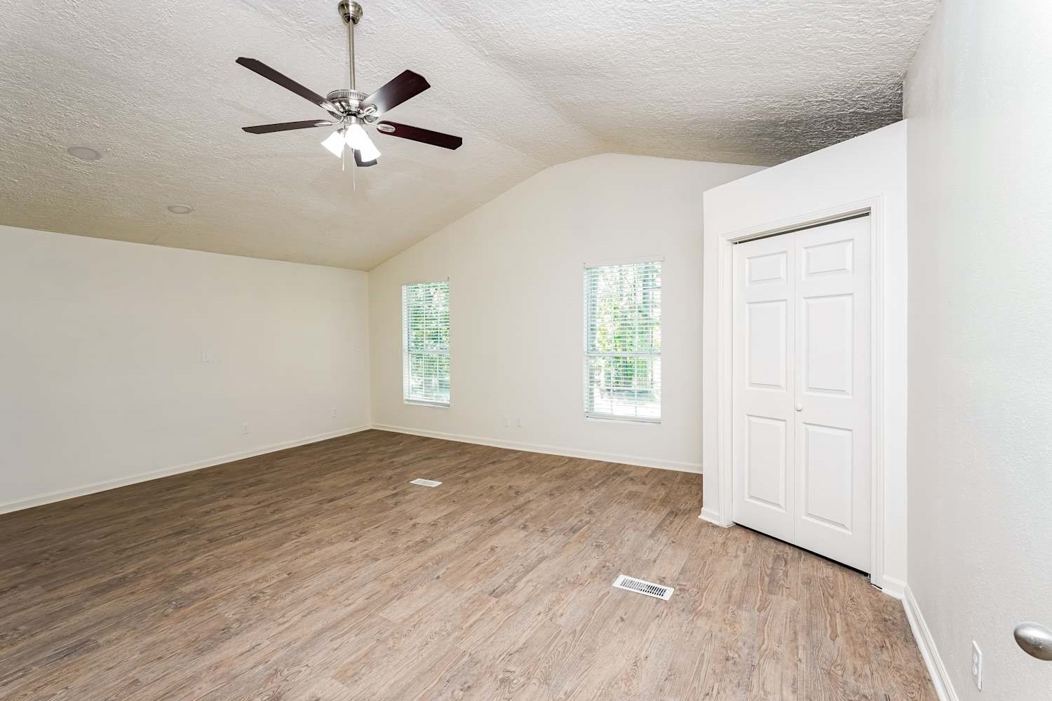 34306 Conroe Huffsmith Road Magnolia, TX 77354 - Photo 9 of 17 an empty room with windows and fan