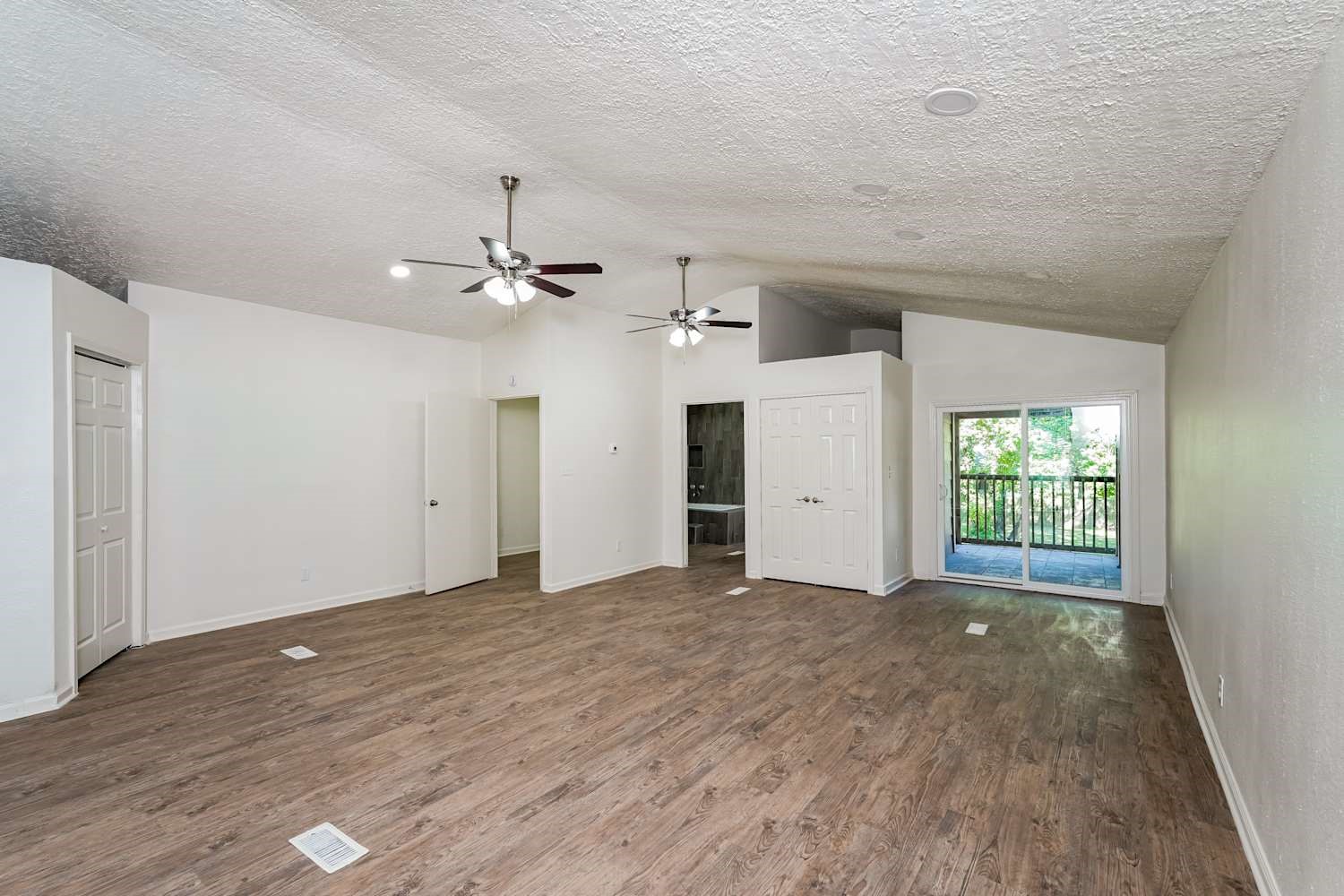 34306 Conroe Huffsmith Road Magnolia, TX 77354 - Photo 10 of 17 a view of a livingroom with a ceiling fan window and wooden floor