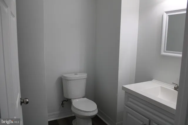 a white toilet sitting next to a bathroom sink