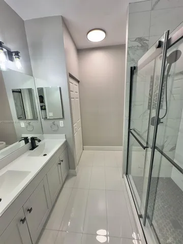 a bathroom with a toilet sink and shower