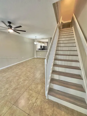 a view of staircase with white walls and windows