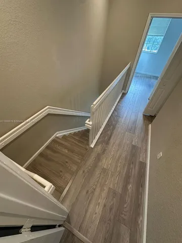 a view of balcony with wooden floor