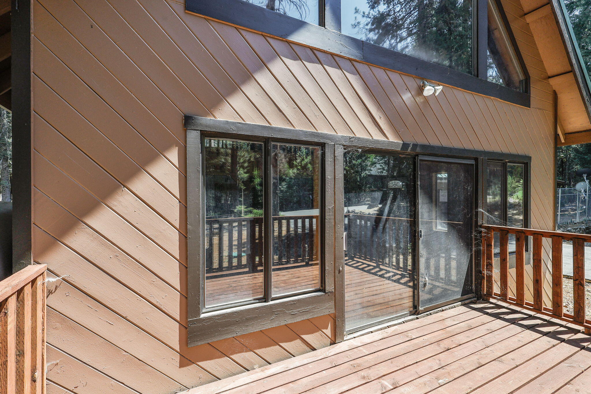 8238 Starlite Pines Road Shingletown, CA 96088 - Photo 22 of 25 a view of a balcony with wooden floor and iron stairs