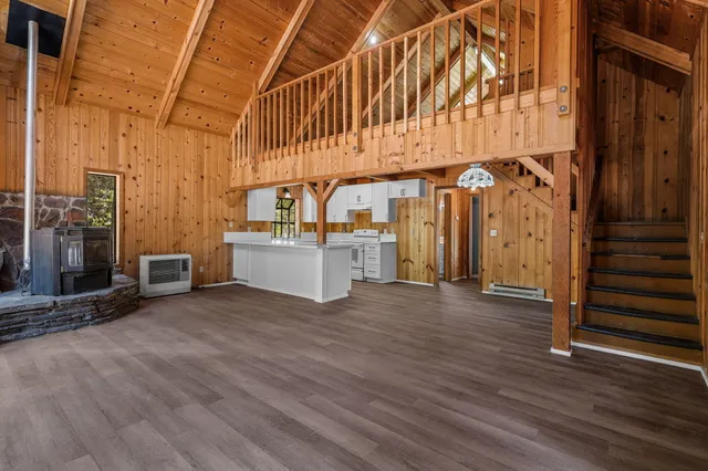 a view of a room with wooden floor and stairs
