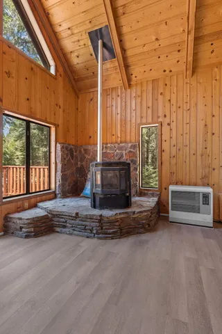 a living room with couch a fireplace and a large window