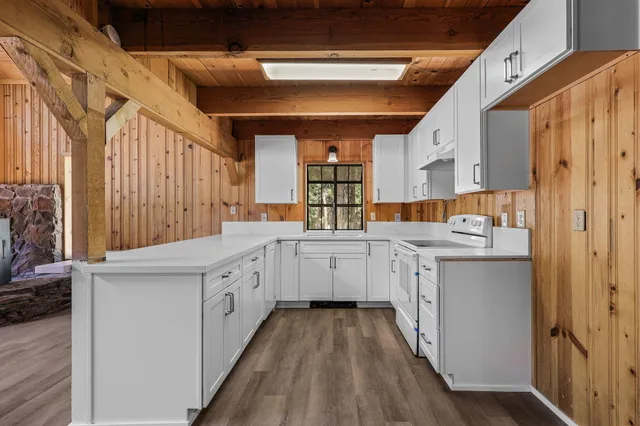 a kitchen with a stove and white cabinets