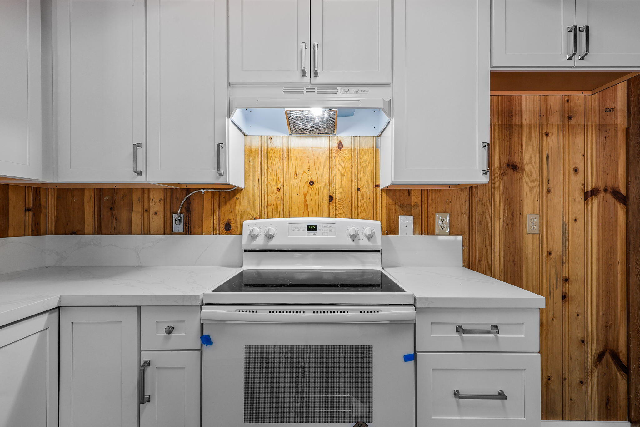 8238 Starlite Pines Road Shingletown, CA 96088 - Photo 6 of 25 a kitchen with a stove and white cabinets