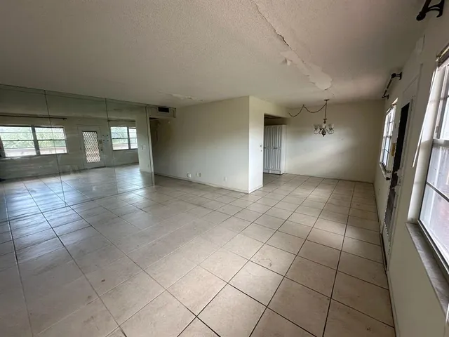 an empty room with large windows