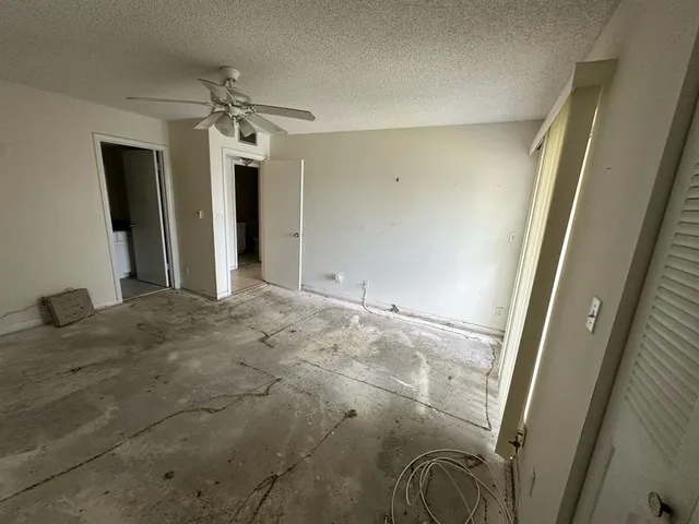 a bathroom with a granite countertop sink toilet and mirror