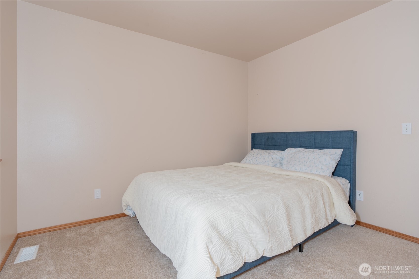 27309 111th Place Southeast Kent, WA 98030 - Photo 11 of 20 a large bed sitting in a bedroom next to a wall
