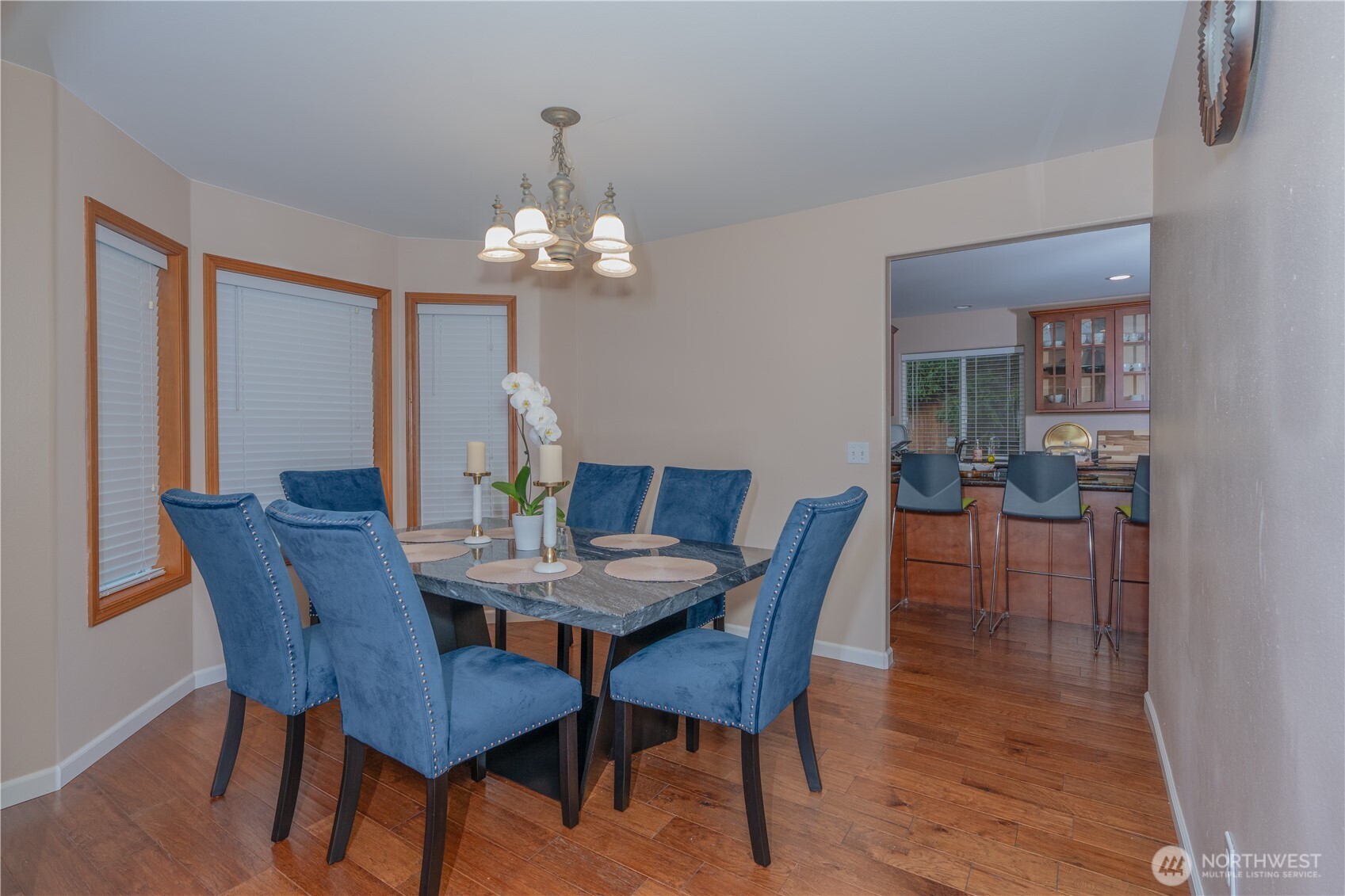 27309 111th Place Southeast Kent, WA 98030 - Photo 5 of 20 a view of a dining room with furniture a chandelier and wooden floor