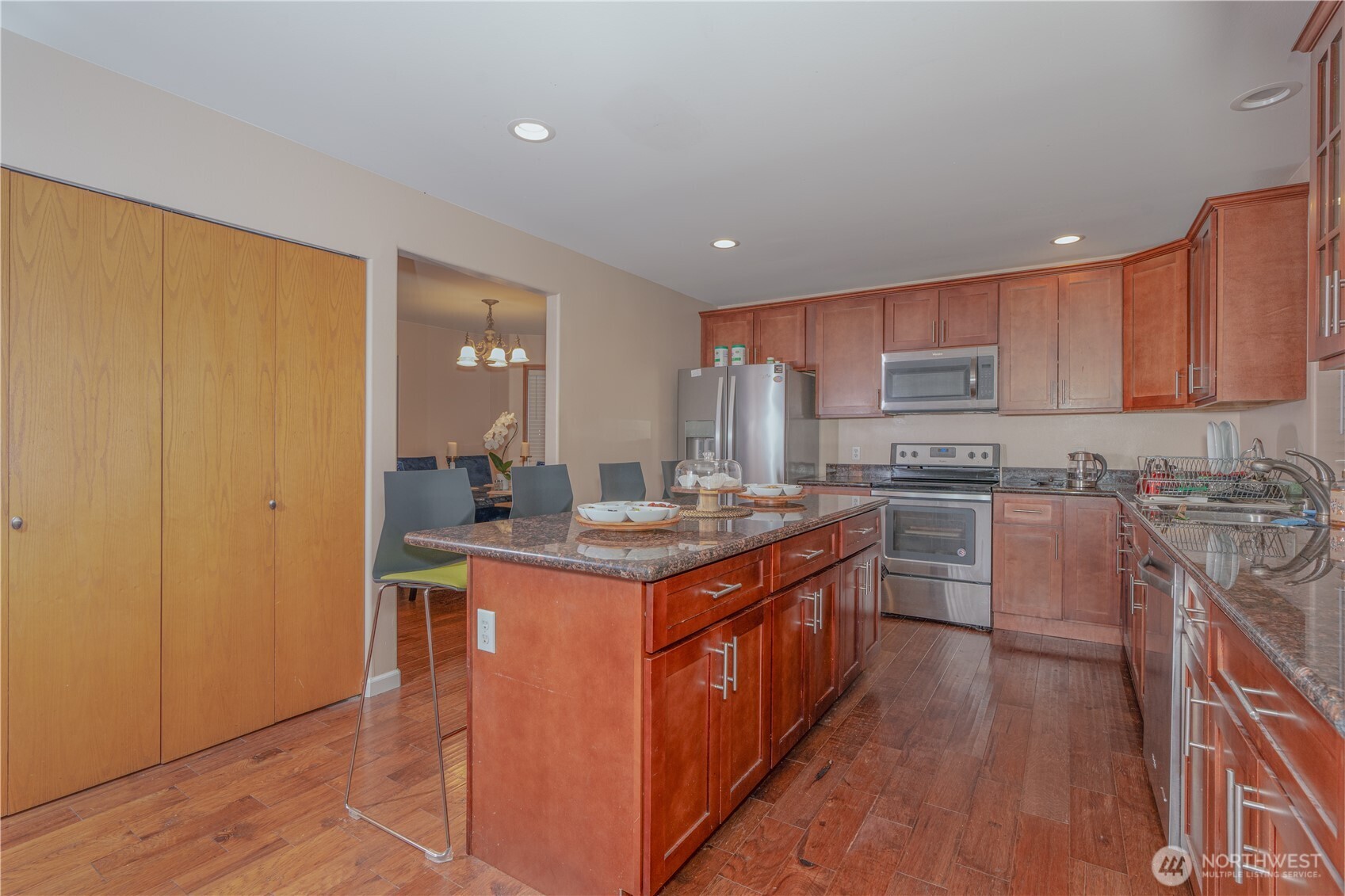 27309 111th Place Southeast Kent, WA 98030 - Photo 9 of 20 a kitchen with stainless steel appliances granite countertop a stove top oven a sink dishwasher and a refrigerator with wooden floor