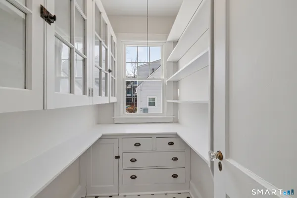 a bathroom with a granite countertop sink a toilet and shower