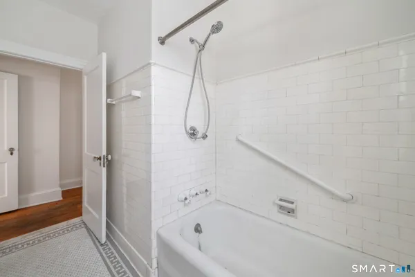 a view of empty room with wooden floor