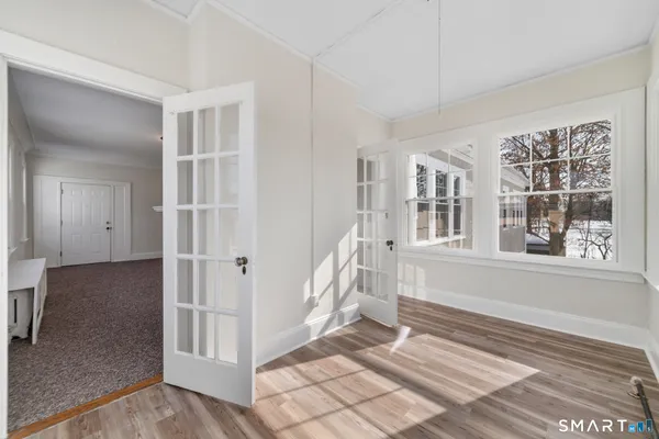 wooden floor in an empty room with a window