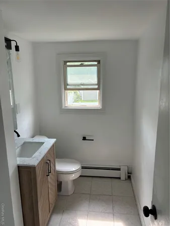 a bathroom with a sink a toilet and a mirror