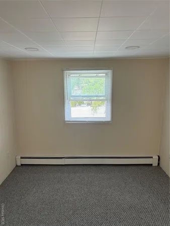 a view of a room with an empty space and a window