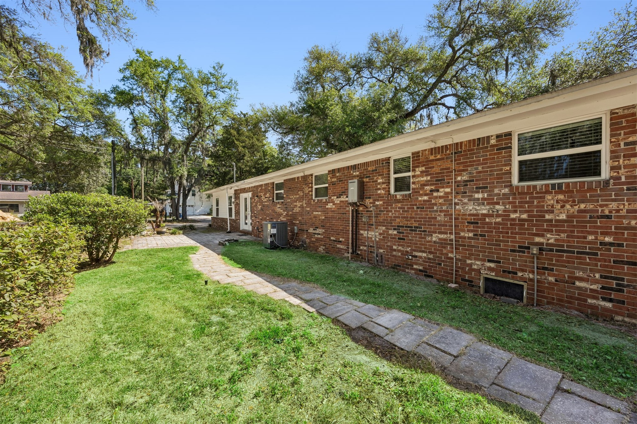 2441 Amelia Road Fernandina Beach, FL 32034 - Photo 33 of 36 a backyard of a house with lots of green space