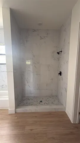 a bathroom with bathtub and shower