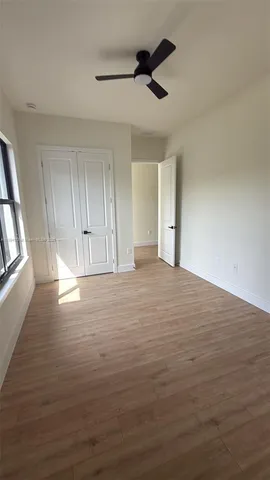 a view of a room with wooden floor and cabinet
