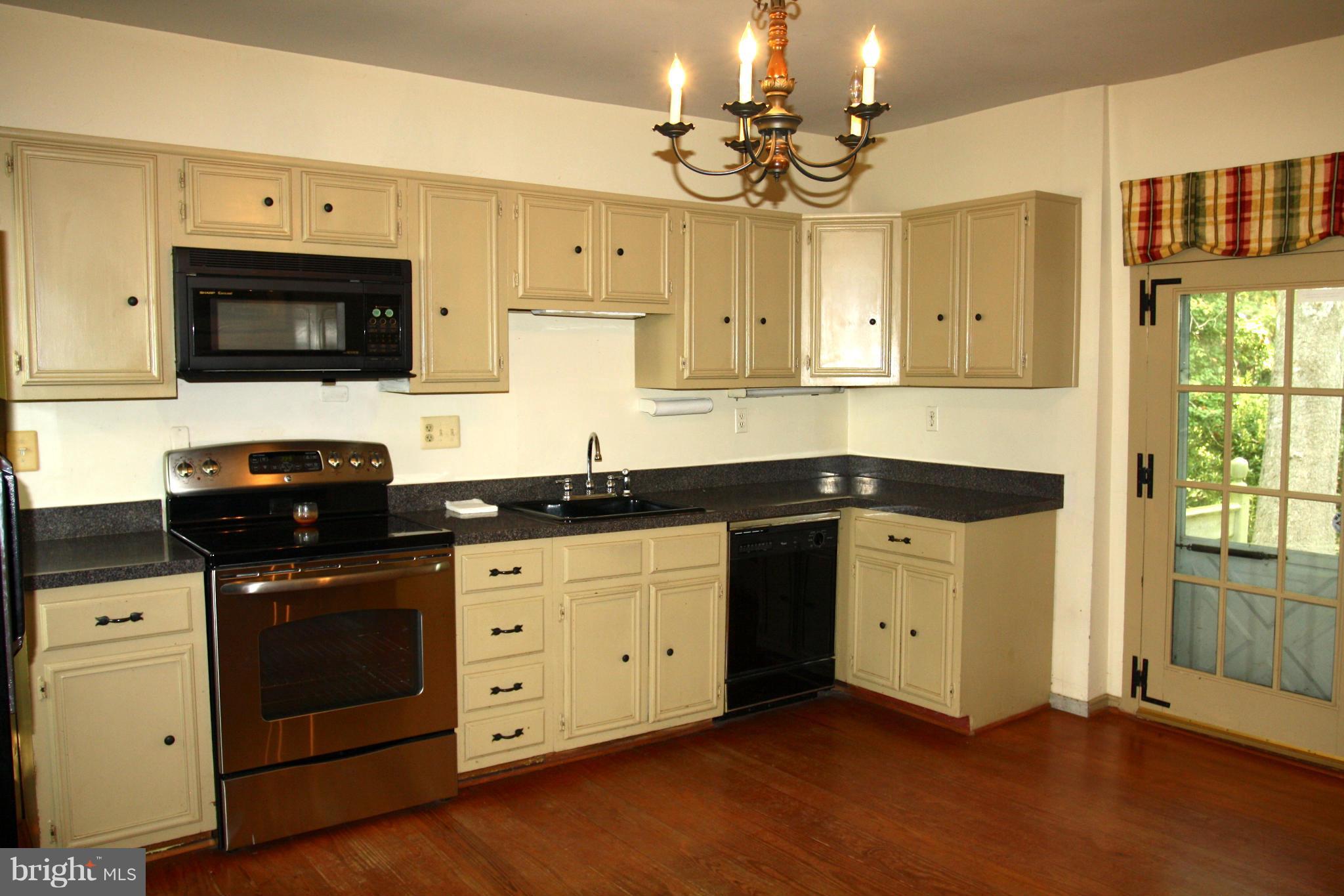 4000 Chaneyville Road Owings, MD 20736 - Photo 5 of 30 a kitchen with a sink stove and microwave