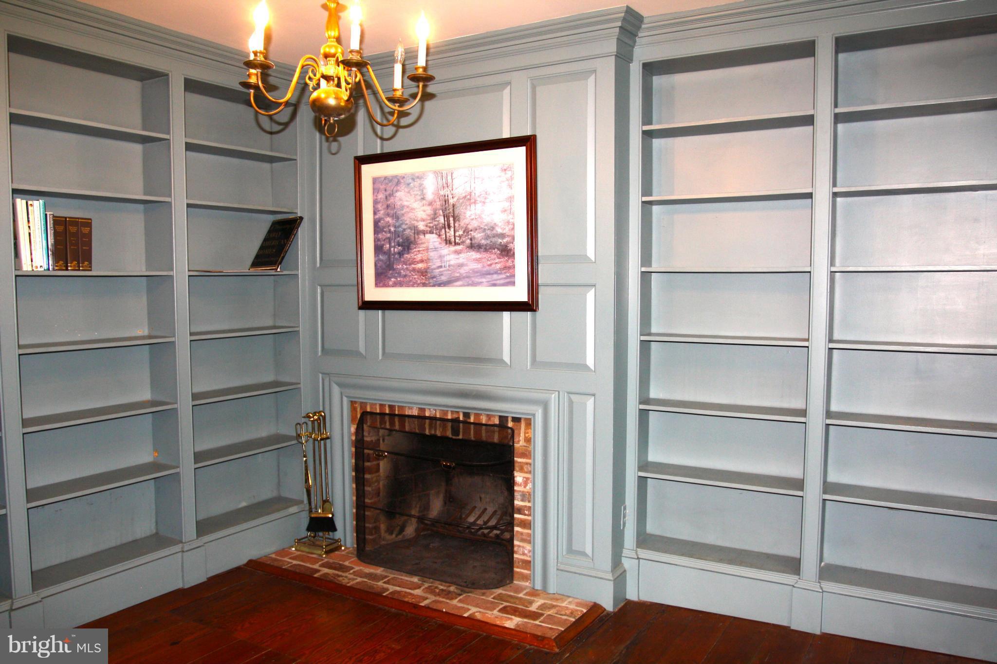 4000 Chaneyville Road Owings, MD 20736 - Photo 9 of 30 a living room with a fireplace cabinet and a window