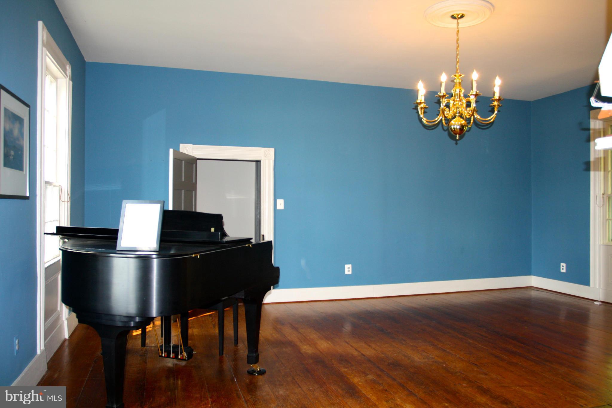 4000 Chaneyville Road Owings, MD 20736 - Photo 10 of 30 a living room with furniture and a chandelier