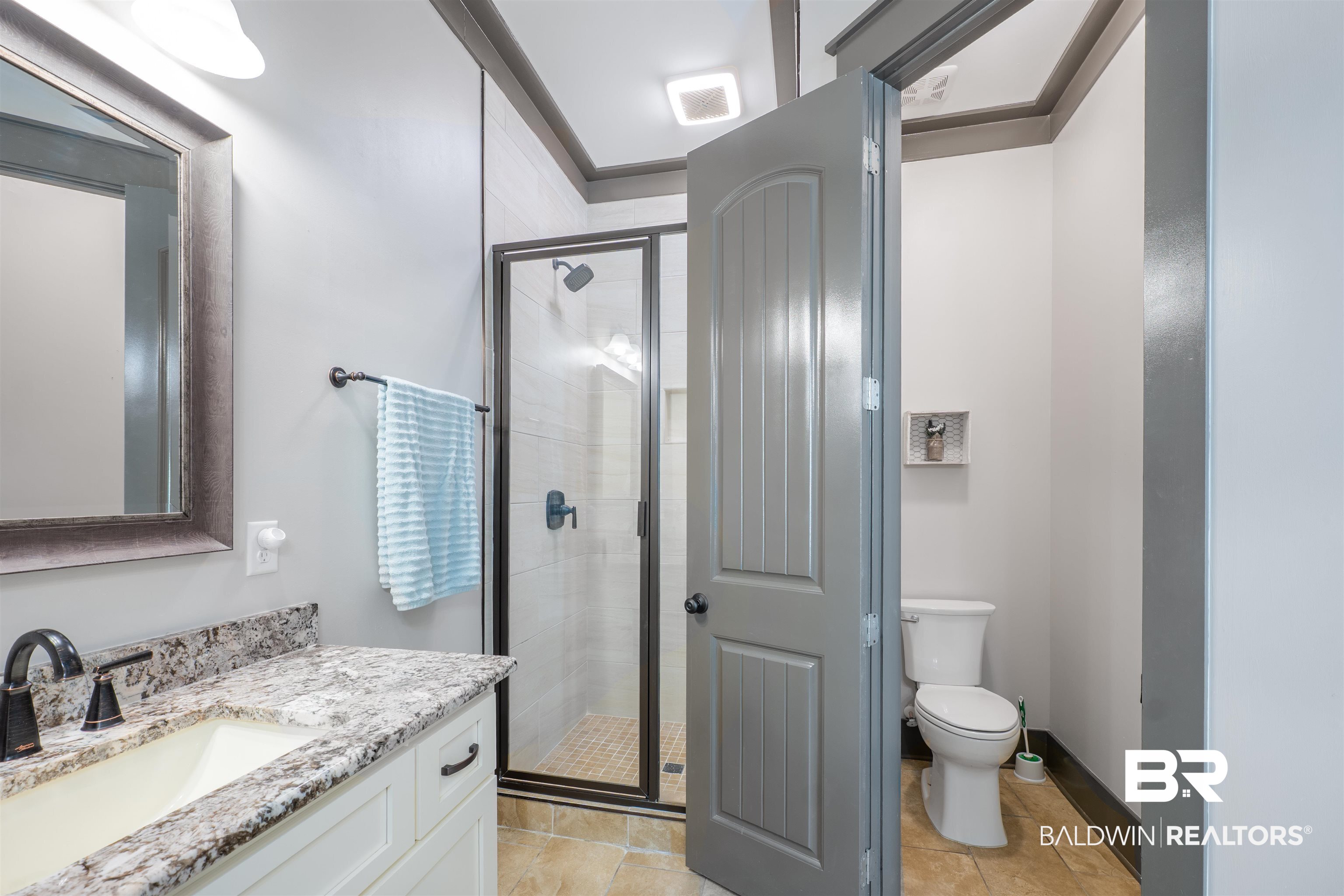 1119 Pink Poppy Lane Foley, AL 36535 - Photo 15 of 38 Full bath with vanity, a shower stall, water closet, and light tile patterned floors