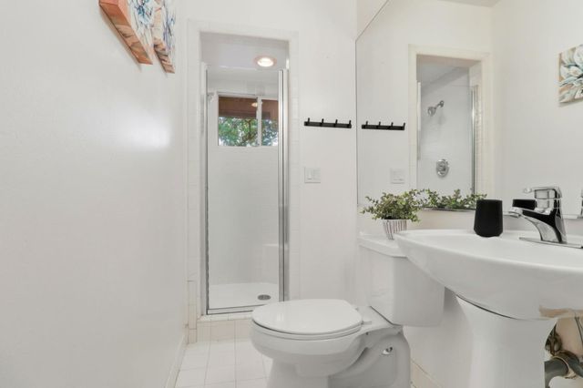 a bathroom with a sink toilet and mirror