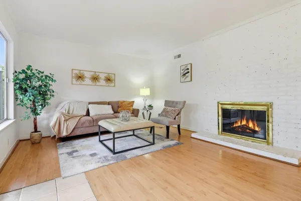 a living room with furniture and a fireplace