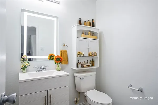 a bathroom with a toilet sink and mirror