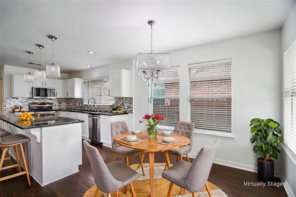 a living room with dining table furniture dining table and a chandelier