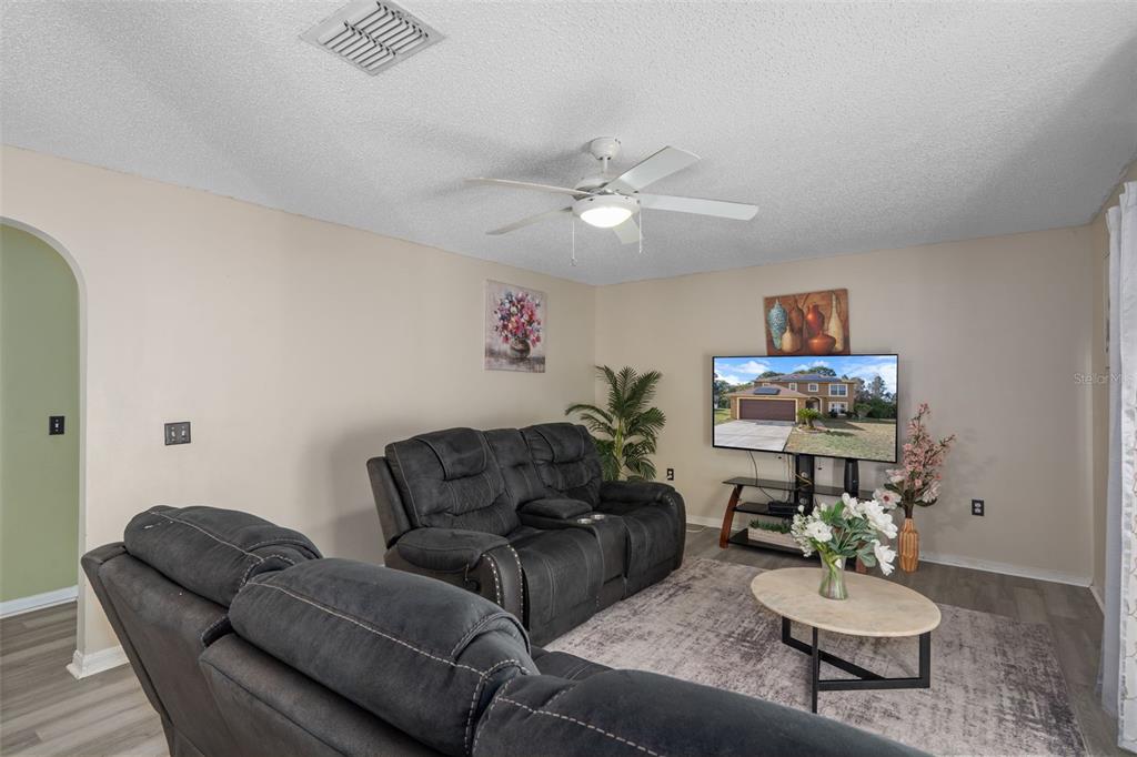 2359 Gimlet Avenue Spring Hill, FL 34608 - Photo 17 of 52 a living room with furniture and a wooden floor
