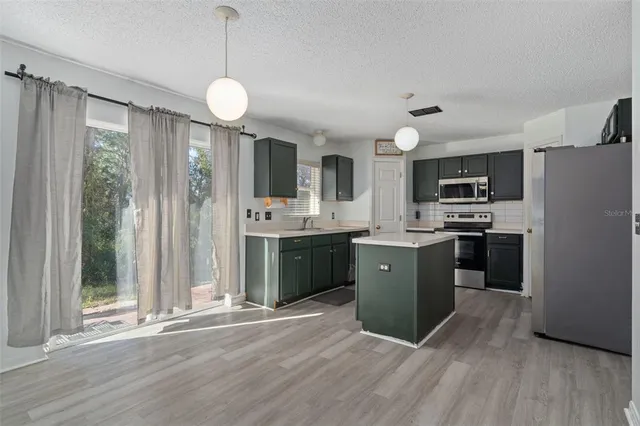 a view of a livingroom with wooden floor and furniture