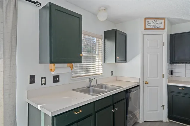 a kitchen with a sink stove and refrigerator