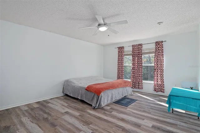 a bedroom with a large bed and a chandelier