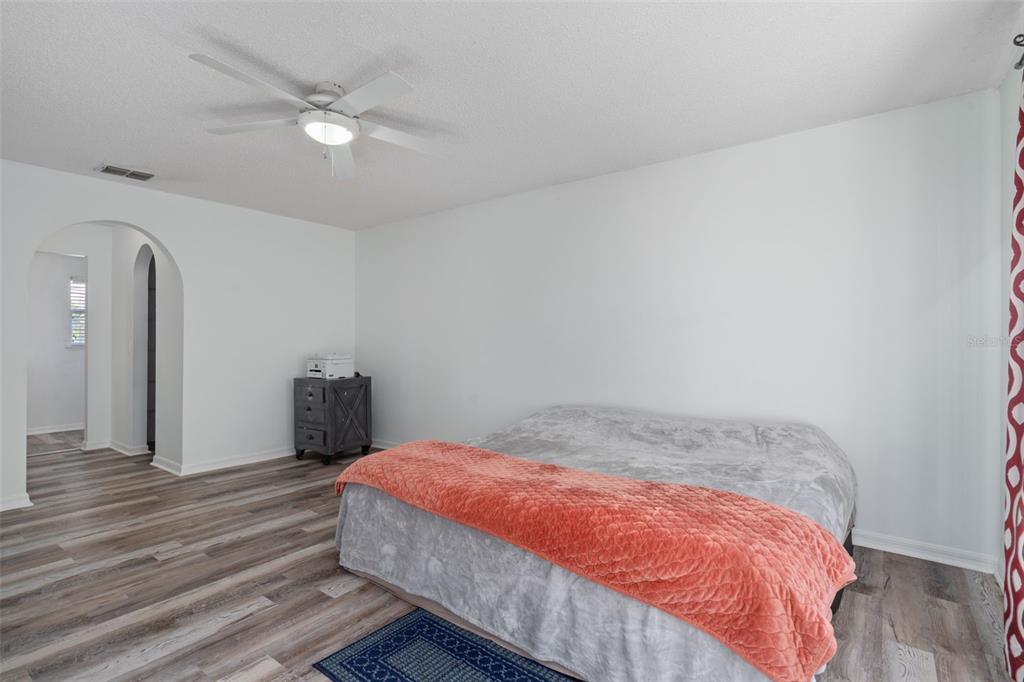 2359 Gimlet Avenue Spring Hill, FL 34608 - Photo 34 of 52 a bedroom with a bed and a chandelier