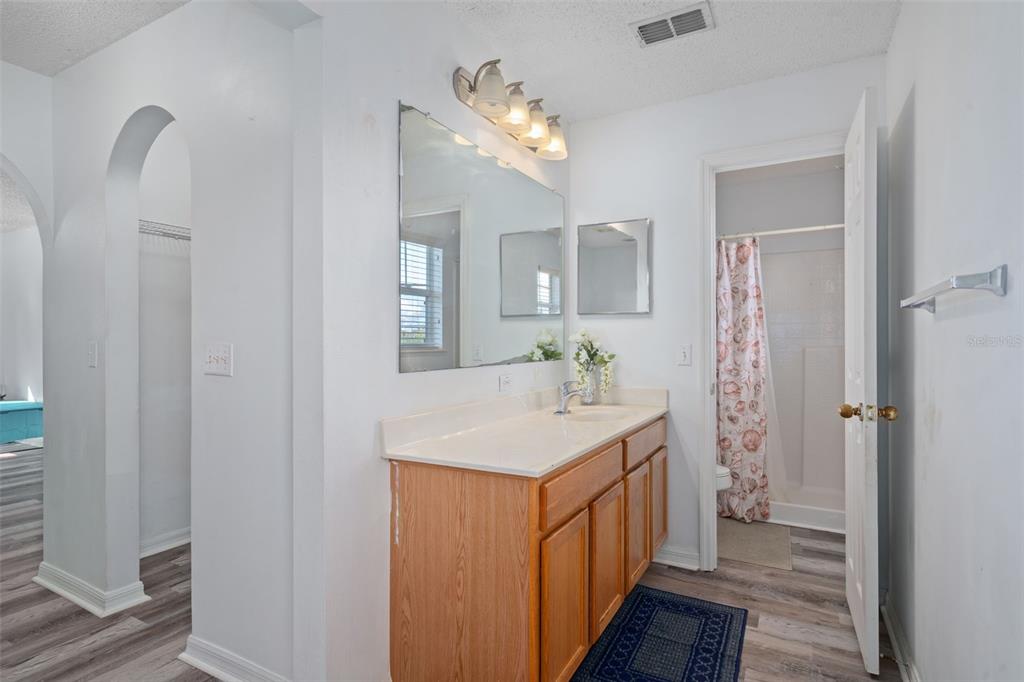 2359 Gimlet Avenue Spring Hill, FL 34608 - Photo 40 of 52 a bathroom with a sink a mirror and a shower