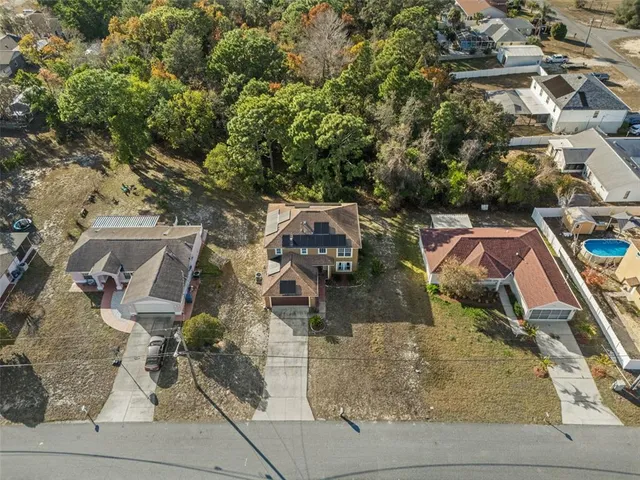 an aerial view of a house with outdoor space