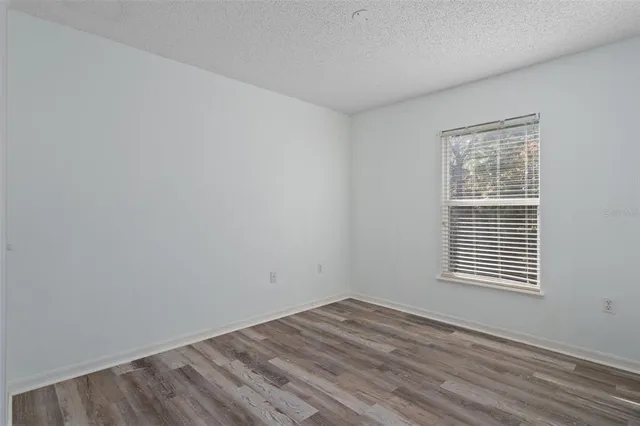 a bedroom with a bed and a chair