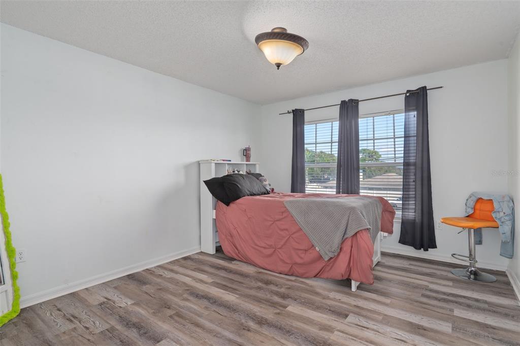 2359 Gimlet Avenue Spring Hill, FL 34608 - Photo 47 of 52 a bed room with a bed and a chair