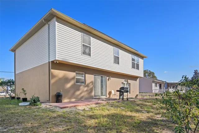 a view of a house with a backyard