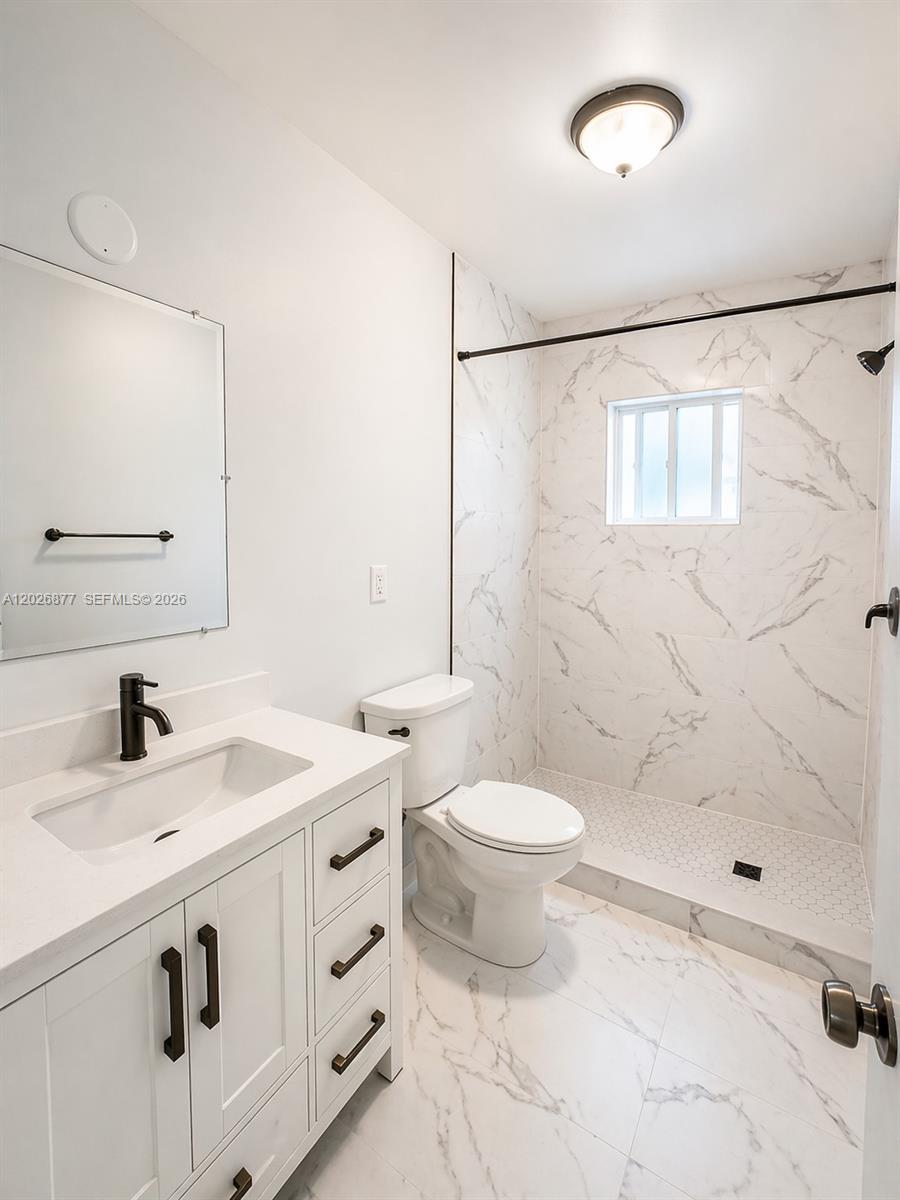 2727 Southwest 24th Street Miami, FL 33145 - Photo 7 of 18 a bathroom with a sink toilet and shower