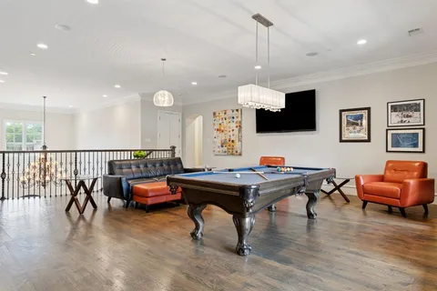 a kitchen with granite countertop a table and chairs in it