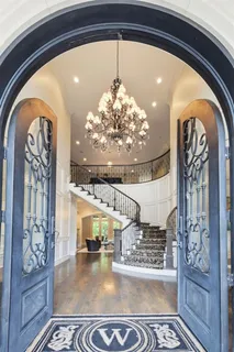a living room with furniture a fireplace and a chandelier