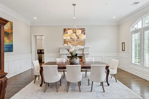 a view of a dining room with furniture wooden floor and chandelier